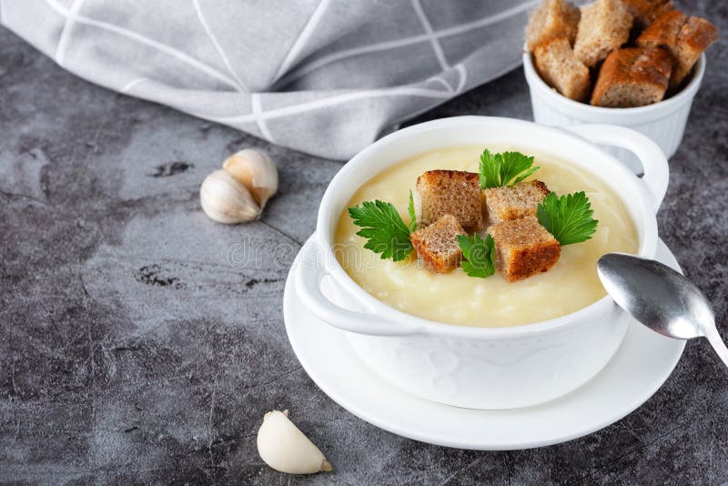 Cauliflower potato soup puree on stone background, Creamy cauliflower soup