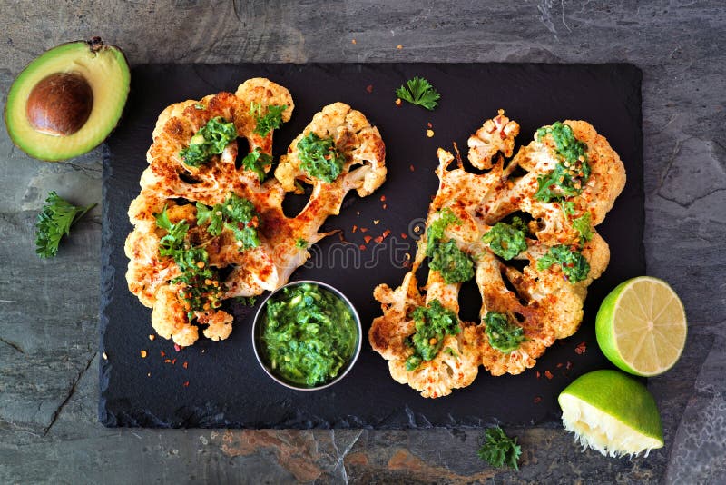 Cauliflower steaks above view on a slate platter, healthy plant based meat substitute concept royalty free stock photos Cauliflower steaks above view on a slate platter, healthy plant based meat substitute concept royalty free stock photos