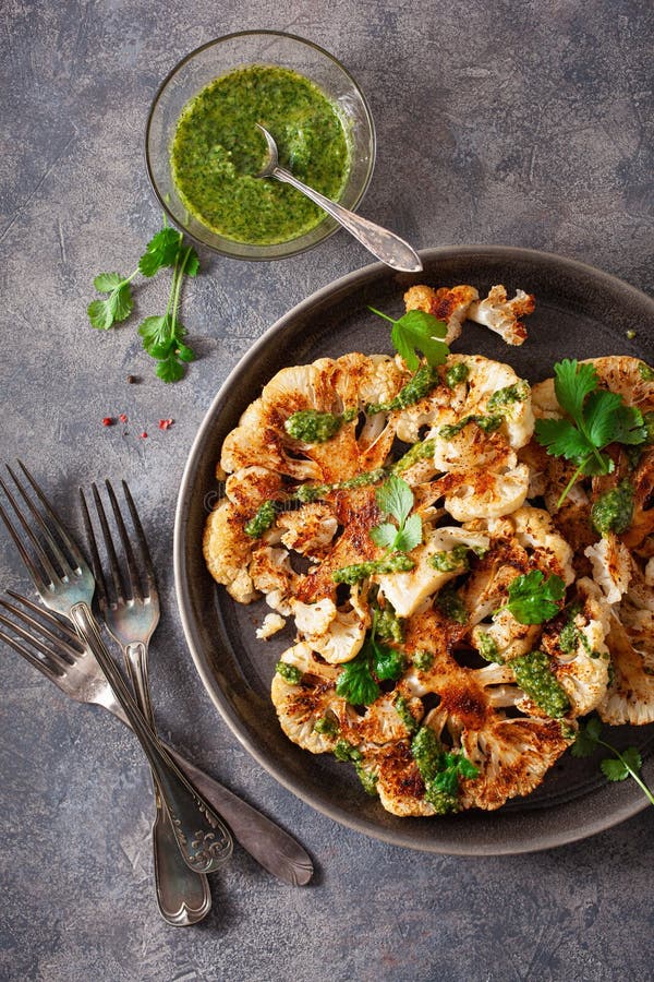 Cauliflower Steaks with Herb Sauce and Spice. Plant Based Meat