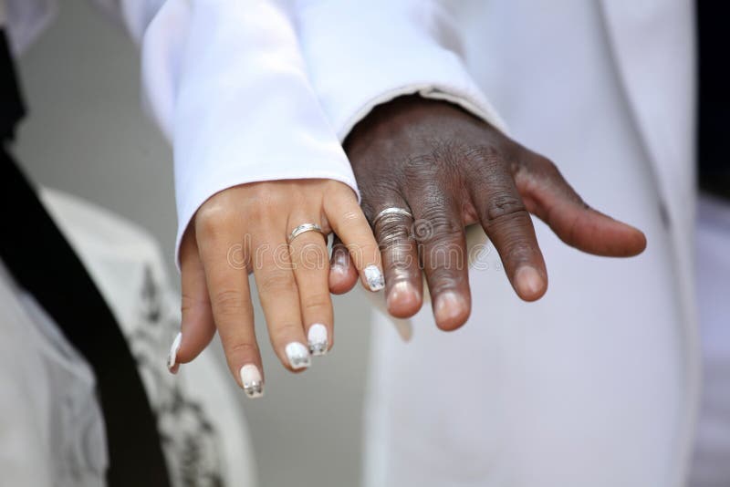 Causian and African-American couple holding hand