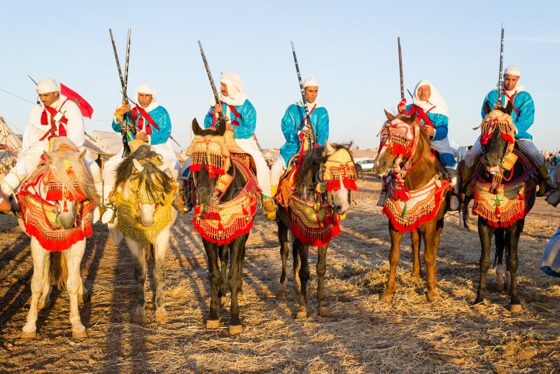 Cavaleiros marroquinos do cavalo durante o festival da fantasia