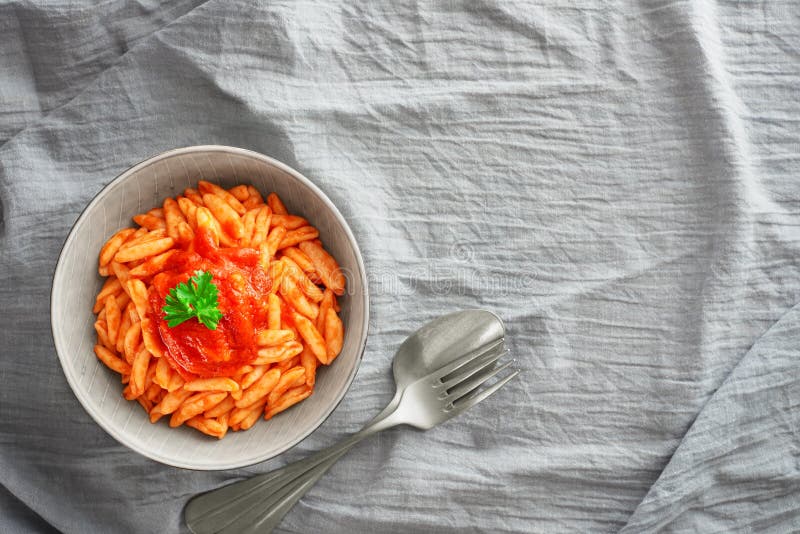 Cavatelli Pasta in Tomato Sauce Closeup Top View with Copy Space Stock
