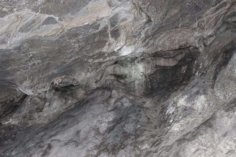 Cave wall, stone background texture. Gray karst cave. Rock formations in the cave, stalactites and stalagmites. Abstract gray grunge background. Stone texture background. Spotted abstract stone. Russia, Bashkortostan, Ural. Cave wall, stone background texture. Gray karst cave. Rock formations in the cave, stalactites and stalagmites. Abstract gray grunge background. Stone texture background. Spotted abstract stone. Russia, Bashkortostan, Ural