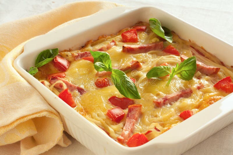 Casserole with cheese, bacon and tomatoes in white pan. Casserole with cheese, bacon and tomatoes in white pan