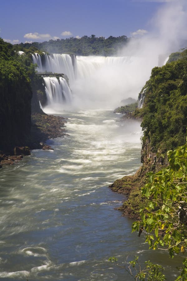 Iguassu Falls is the largest series of waterfalls on the planet, located in Brazil, Argentina, and Paraguay in South America. During the rainy season one can see as many as 275 separate waterfalls cascading along the edges of 2,700 meters or 1.6 miles cliffs. Argentines spells this wonder, Ã¬IguazuÃ®, the Brazilians, Ã¬Igaucu.Ã® Both versions are globally correct and widely used. South America. Iguassu Falls is the largest series of waterfalls on the planet, located in Brazil, Argentina, and Paraguay in South America. During the rainy season one can see as many as 275 separate waterfalls cascading along the edges of 2,700 meters or 1.6 miles cliffs. Argentines spells this wonder, Ã¬IguazuÃ®, the Brazilians, Ã¬Igaucu.Ã® Both versions are globally correct and widely used. South America