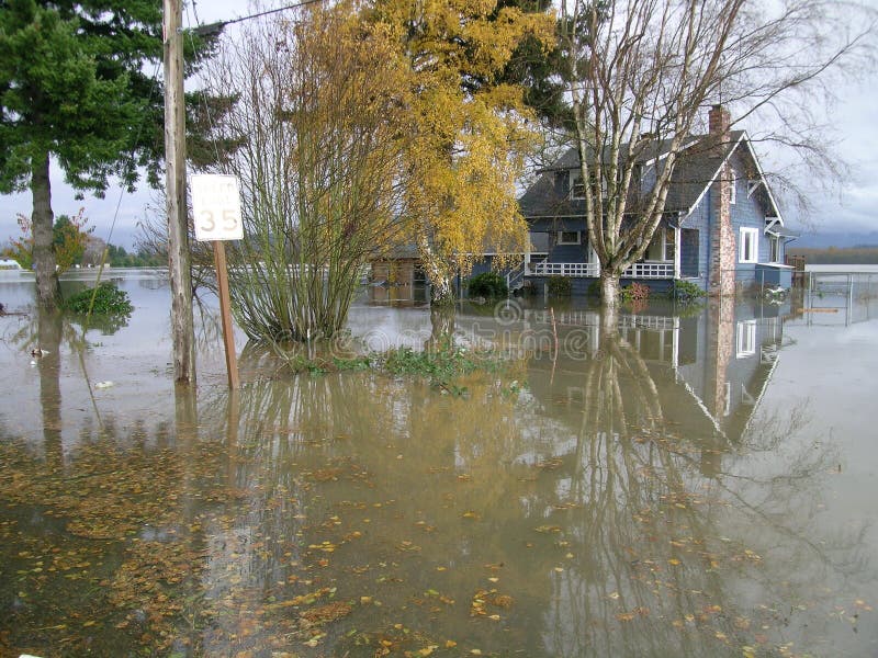 Floodwaters completely surround a home in Western Washington, USA,. Floodwaters completely surround a home in Western Washington, USA,