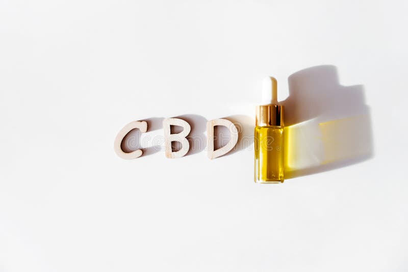 CBD oil dropper bottle iand word cbd isolated on white stock photo CBD oil dropper bottle iand word cbd isolated on white stock photo