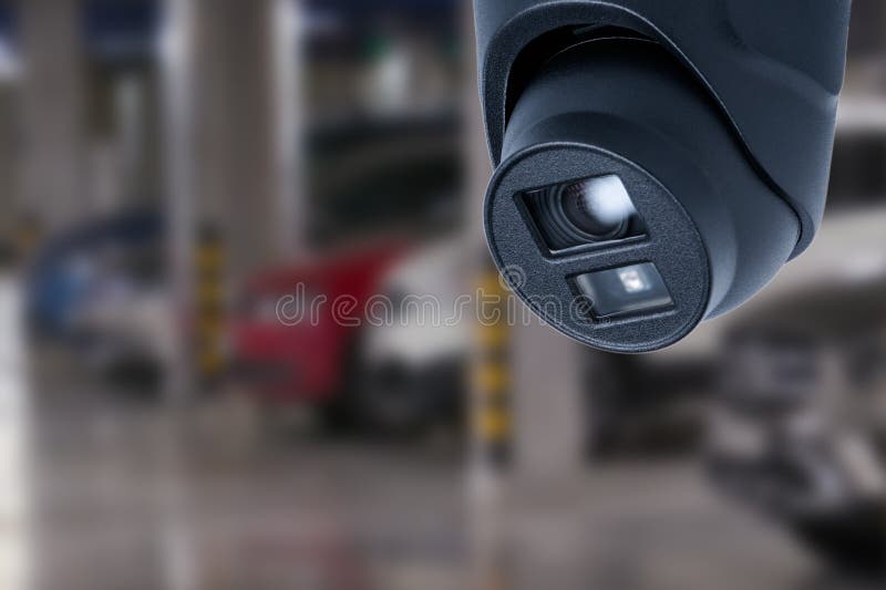 CCTV Camera in Underground Parking Garage. Copy Space. Stock Image
