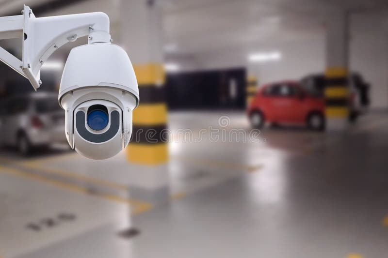 CCTV Camera in Underground Parking Garage. Copy Space. Stock Photo