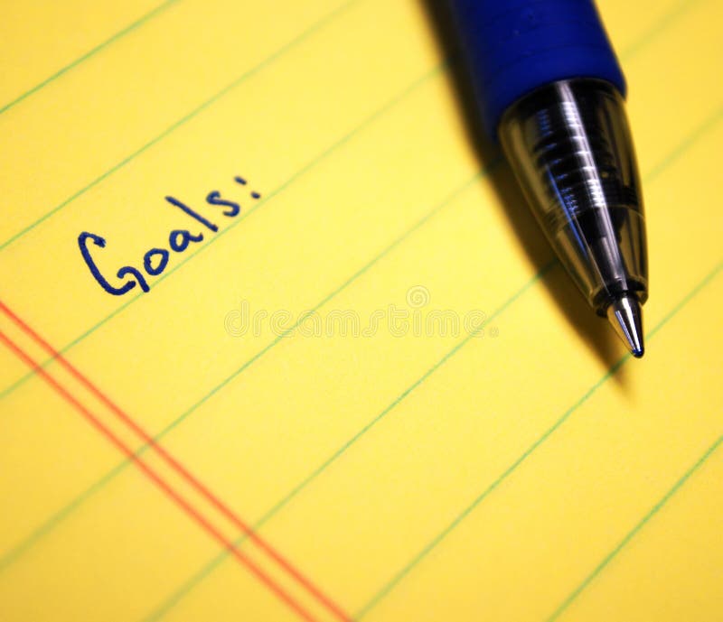 Goals written on yellow paper with blue pen. Goals written on yellow paper with blue pen