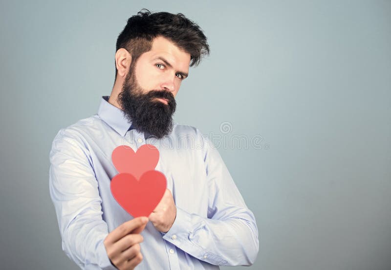 Celebrate love. Guy attractive with beard and mustache in romantic mood. Feeling love. Dating and relations concept stock images