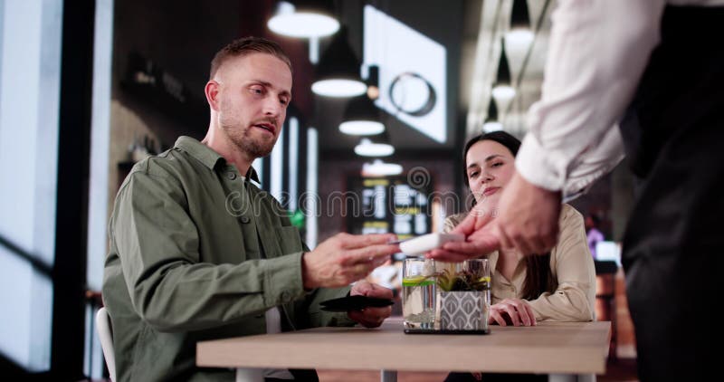 Celebrating In A Dark Restaurant, Paying Bill royalty free stock photography