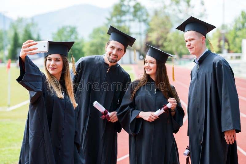 Celebration Education Graduation Student Success Learning Concept. Graduated students taking selfie. stock photo Celebration Education Graduation Student Success Learning Concept. Graduated students taking selfie. stock photo