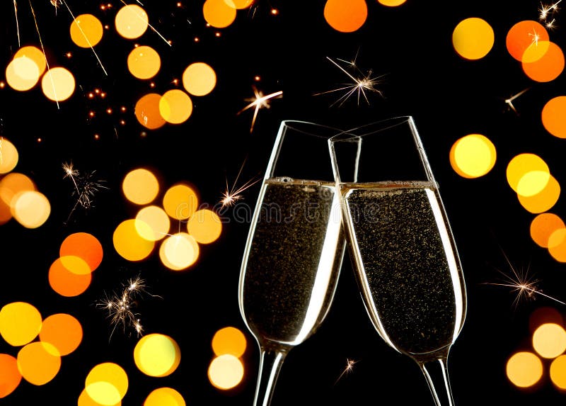 Celebration on New Year`s Eve. Close up of two glasses of Champagne clinking together