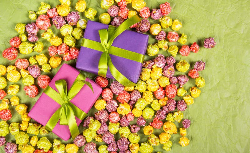 Gifts and sweets. Celebratory background. Multicolored popcorn and gift boxes royalty free stock photo Gifts and sweets. Celebratory background. Multicolored popcorn and gift boxes royalty free stock photo