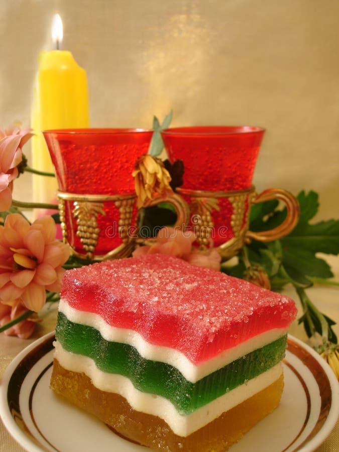 Celebratory table (Color Jelly cake on plate, two red glasses, f