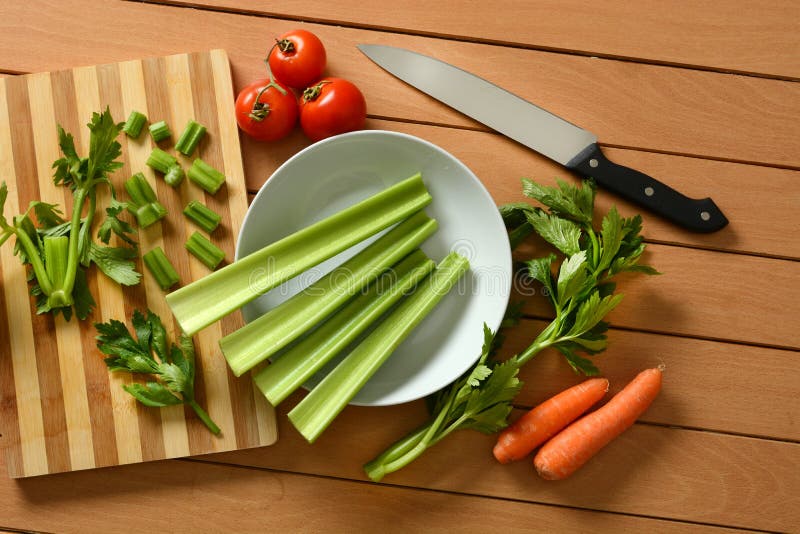 Celery, Carrots and Tomato with Knife beside Stock Photo Image of closeup, uncooked 110486584