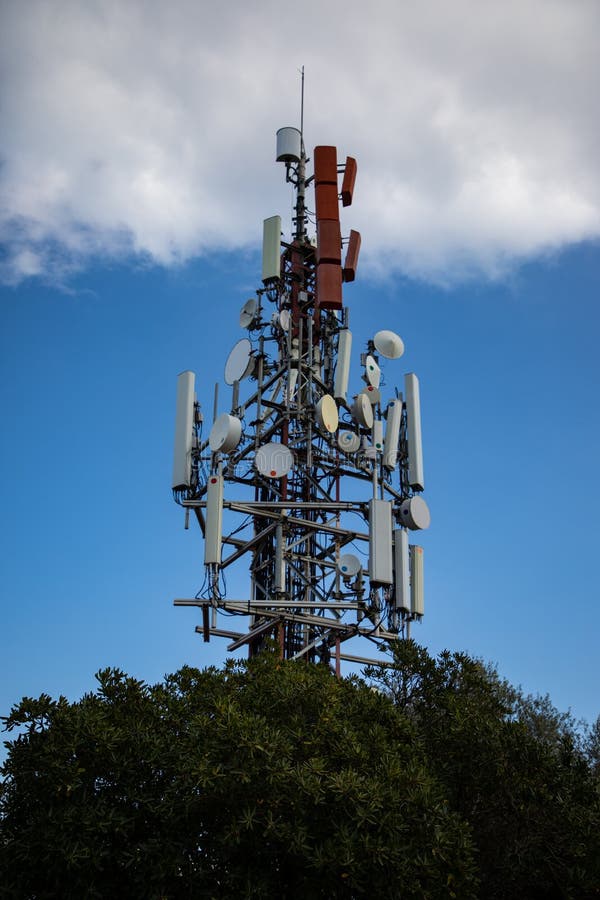 Cell antenna over the tree with cloudy sky stock photography Cell antenna over the tree with cloudy sky stock photography