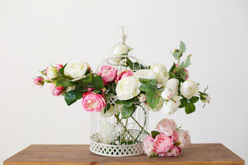 Cell full of rose flowers on a wooden table