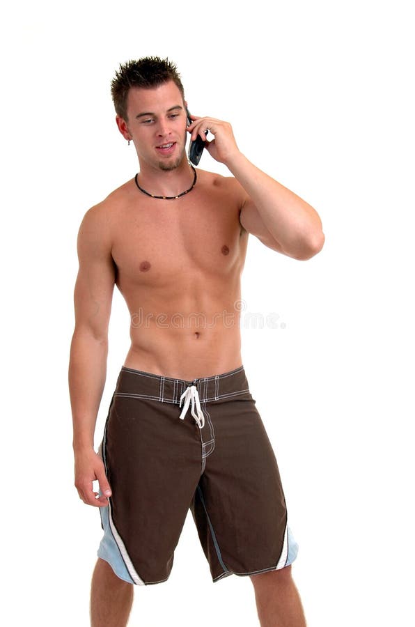 A man in swim suit talking on cell phone