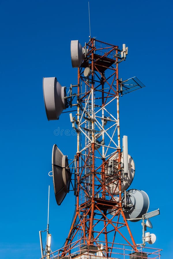 Cell phone relay tower in a bright sunny day. Clear blue sky in stock images Cell phone relay tower in a bright sunny day. Clear blue sky in stock images