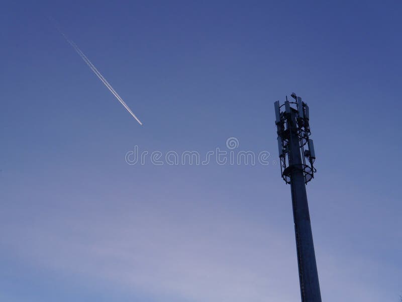 Cell Tower and Trail from an Airplane in the Blue Sky Stock Image