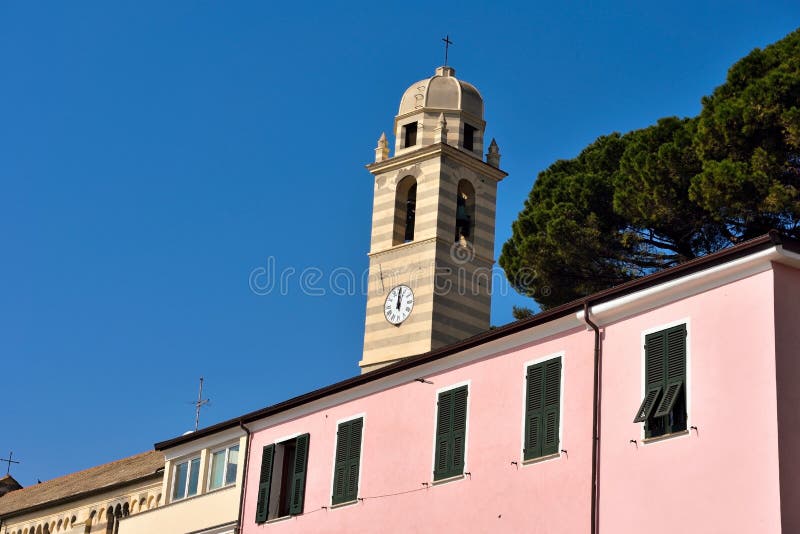 The bell tower of the Church of Our Lady of Consolation and the historic Ligurian houses Celle Ligure Italy. The bell tower of the Church of Our Lady of Consolation and the historic Ligurian houses Celle Ligure Italy