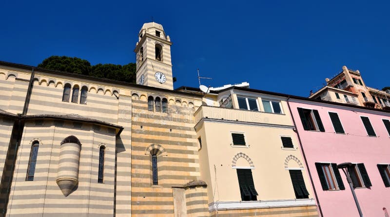 The bell tower of the Church of Our Lady of Consolation and the historic Ligurian houses Celle Ligure Italy. The bell tower of the Church of Our Lady of Consolation and the historic Ligurian houses Celle Ligure Italy