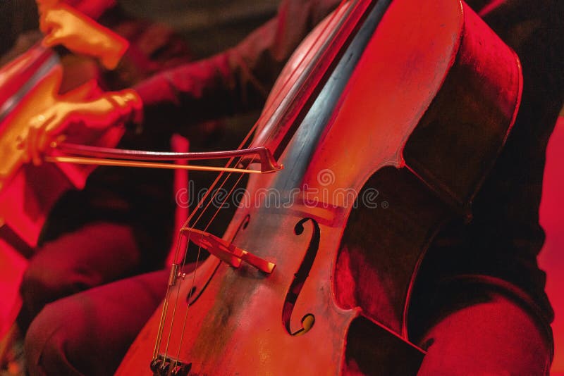 Cellokonzert mit Instrumentabschluß oben. roter brillanten Hintergrund am Rockkonzert