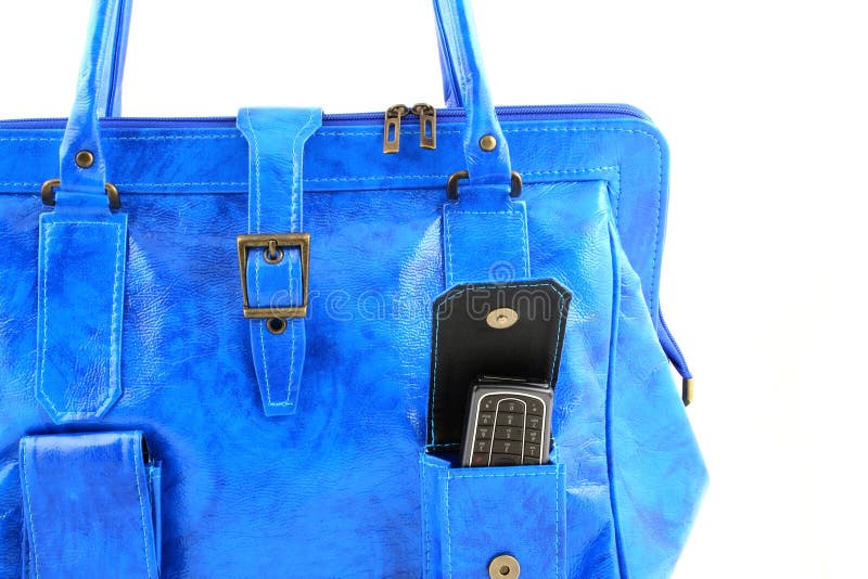 Close up at blue handbag with a cellphone in a pocket. Button clasp stock images, royalty-free photos and pictures
