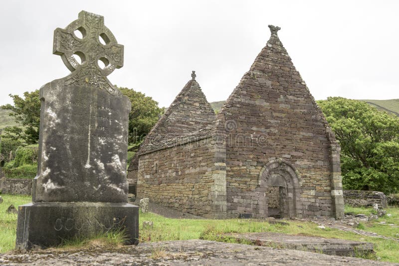 Celtic cross and ruin of church, Ireland. Celtic cross and ruin of ancient Kilmalkedar Church royalty free stock image