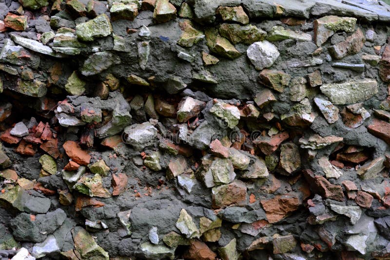 Cement Mix with Fragments of Broken Brick and Stones As a Background