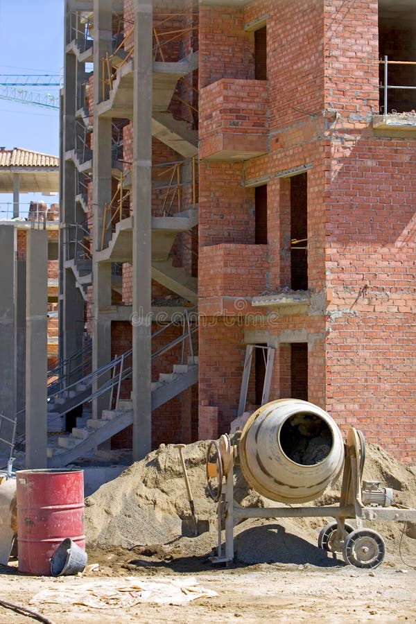 Cement mixer brick building and rubble on Spanish building site on the Costa del Sol in Spain