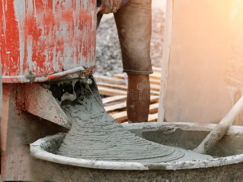 Cement Mixer Pouring in the Basin in Construction Site Stock Photo