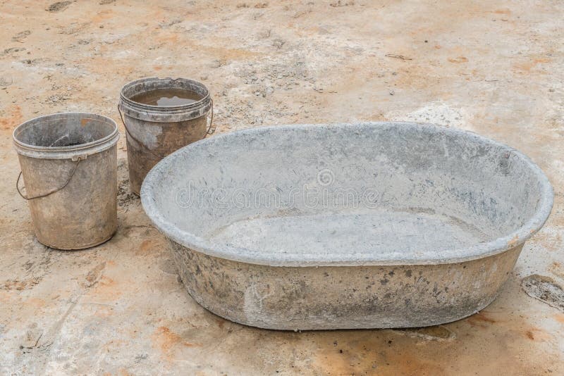 Mixing concrete in tub stock image. Image of glove, build 33655643