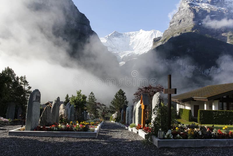 Misty Cemetery located in Grindelwald Switzerland, with the Alps in the background. Misty Cemetery located in Grindelwald Switzerland, with the Alps in the background.