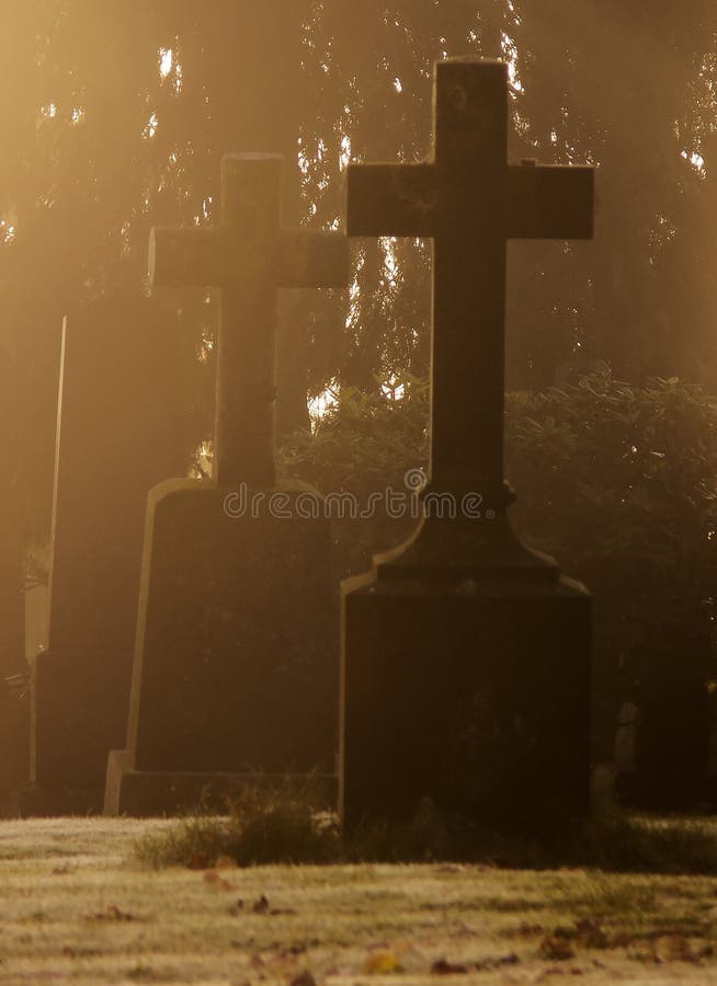 Tombstones with crosses covered in the morning frost and mist. Tombstones with crosses covered in the morning frost and mist