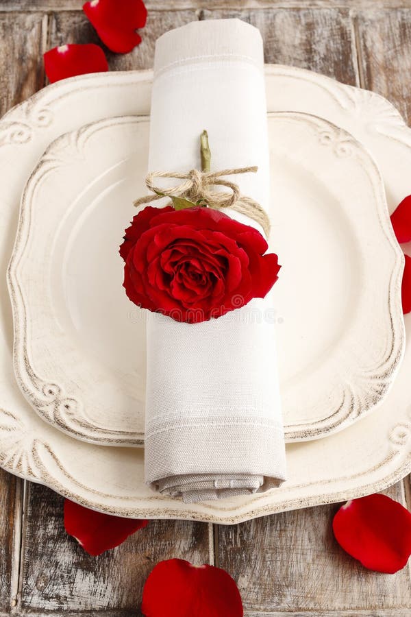 Cena romántica: anillo de servilleta hecho con la rosa del rojo imagen de archivo libre de regalías Cena romántica: anillo de servilleta hecho con la rosa del rojo imagen de archivo libre de regalías