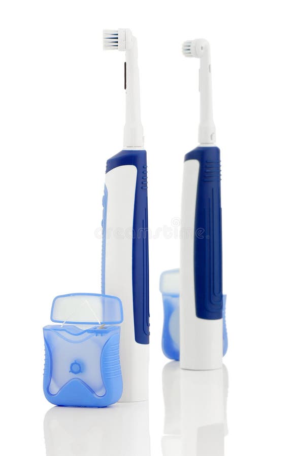 Cepillo de dientes eléctrico y seda dental imágenes de archivo libres de regalías Cepillo de dientes eléctrico y seda dental imágenes de archivo libres de regalías