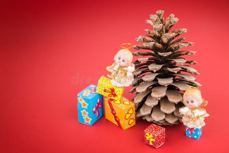 Ceramic Angels, Pincone and Colorful Christmas Gift Boxes Stock Image