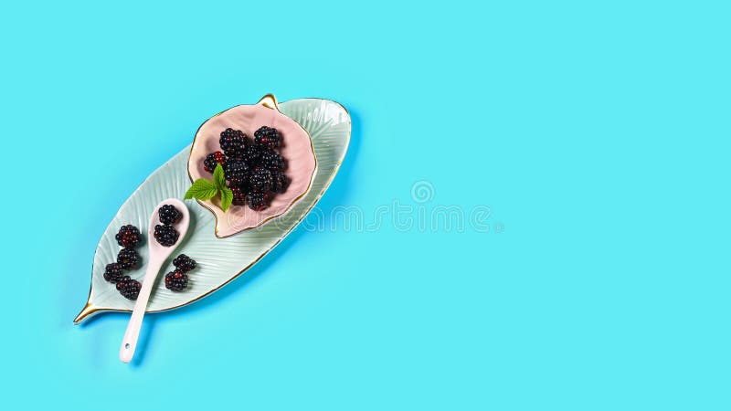 Ceramic Bowl with Blackberries on Blue Background. Close Up, High ...