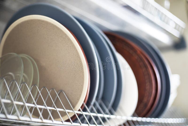 Ceramic and Glass Plates of Different Sizes on a Stand in the Kitchen
