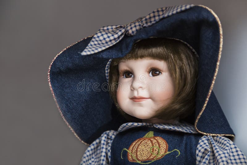 Ceramic porcelain handmade doll with big blue hat