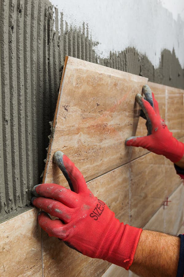 Worker Placing Ceramic Floor Tiles On Adhesive Surface Stock Image