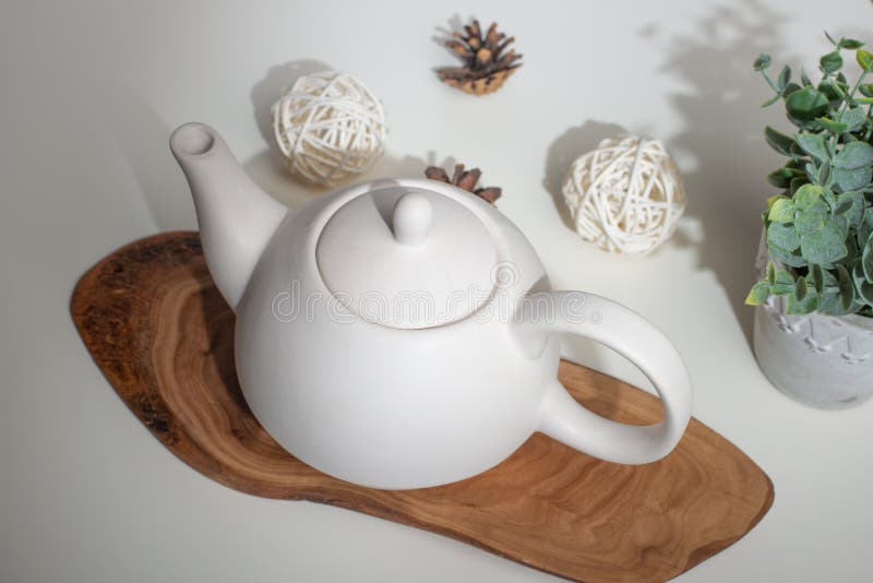 Ceramic White Teapot with Accessories on a White Table, Horizontal