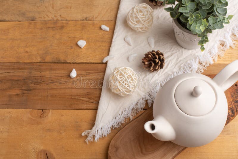 Ceramic White Teapot with Accessories on a Wooden Table, Horizontal