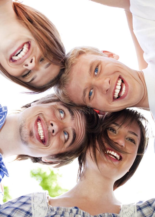 Circle of happy friends with their heads together. Circle of happy friends with their heads together