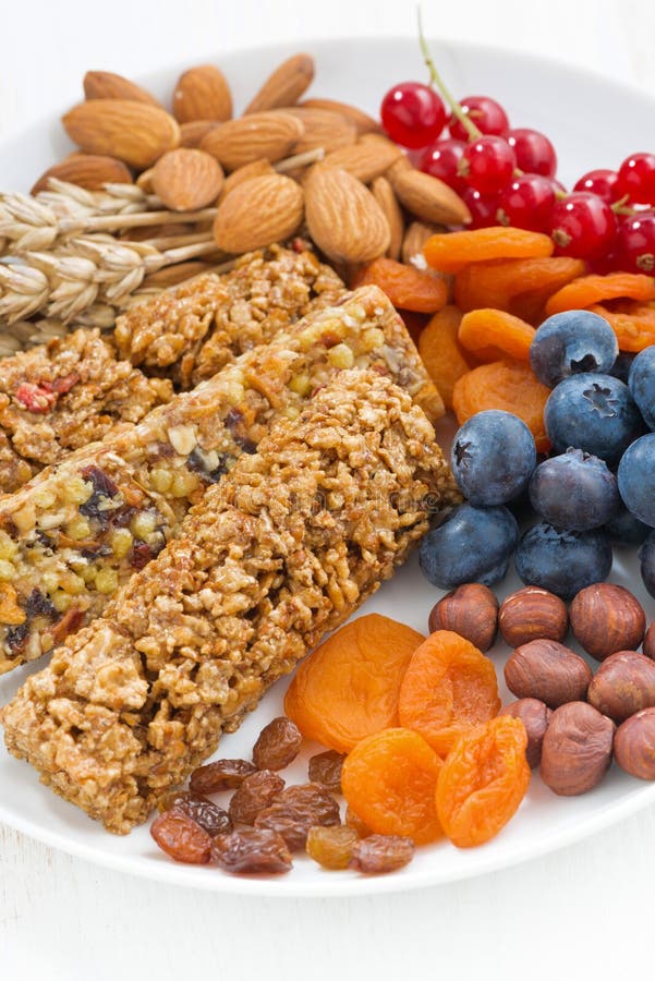 Cereal Muesli Bars, Fresh and Dried Fruit on a Plate, Closeup Stock