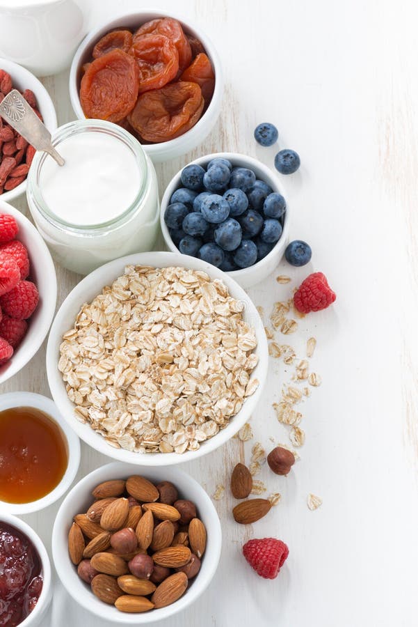 Cereal and various delicious ingredients for breakfast on white