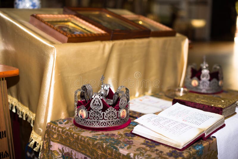 Ceremony of the wedding in the Russian Orthodox Church. The crowns lie near the bible close up stock photography Ceremony of the wedding in the Russian Orthodox Church. The crowns lie near the bible close up stock photography